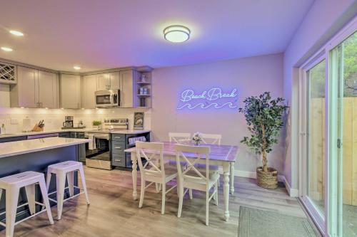 a kitchen with a table and chairs and a purple wall at Beach Break Home with Hot Tub - Walk to Beach in Westport