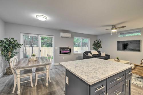 a kitchen and living room with a table and chairs at Beach Break Home with Hot Tub - Walk to Beach in Westport