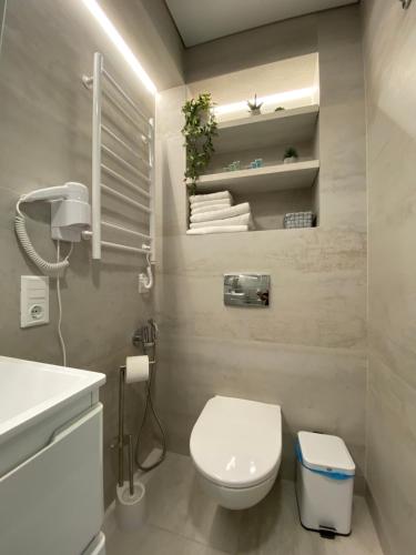 a bathroom with a white toilet and a sink at Zelena Sadyba in Turichki