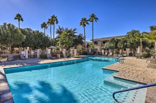 a swimming pool at a resort with palm trees at Families and Dogs Welcome! Phoenix Condo with Pool in Phoenix