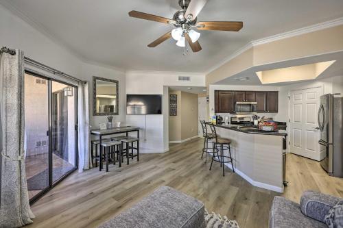 a kitchen and living room with a ceiling fan at Families and Dogs Welcome! Phoenix Condo with Pool in Phoenix