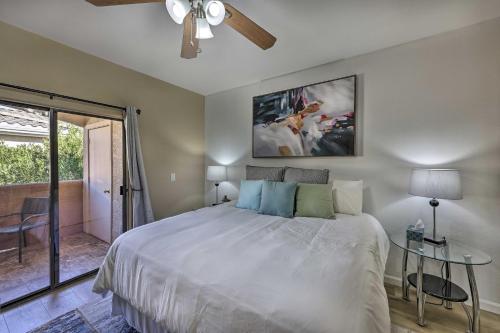 a bedroom with a large bed with a ceiling fan at Phoenix Condo with Pool and Hot Tub - Dog Friendly! in Phoenix