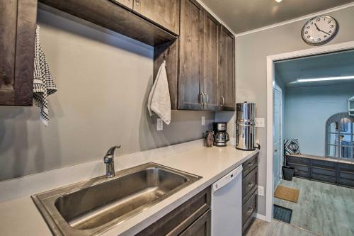 a kitchen with a sink and a clock on the wall at Cozy Cle Elum Cabin with 3 Acres and Stocked Pond in Cle Elum