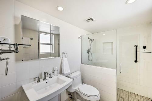 a bathroom with a toilet and a sink and a shower at Stunning Old Town Condo Pool and Sunset Views! in Scottsdale