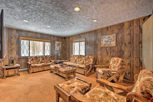 a living room with wooden walls and furniture and windows at Cozy Lake Ariel Home with Community Amenities! in Lake Ariel