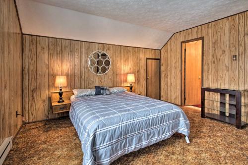 a bedroom with a bed and two lamps in it at Cozy Lake Ariel Home with Community Amenities! in Lake Ariel