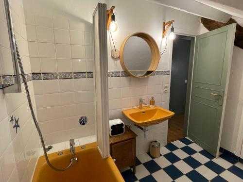 a bathroom with a yellow sink and a mirror at Clos Sanouva, Fougère in Le Breuil-en-Auge
