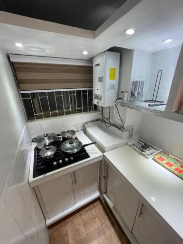a small kitchen with a stove and some pots and pans at Departamento Concepcion in Concepción