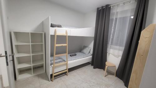 a room with two bunk beds and a ladder at Betariel Golf Club Villas in Velm
