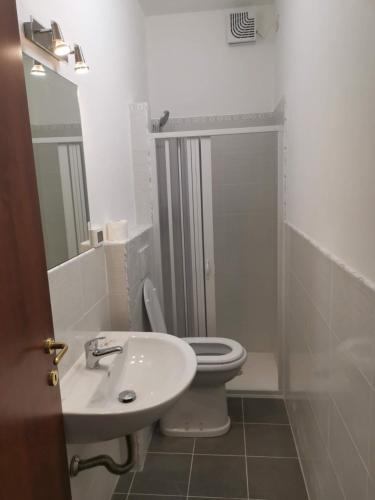 a bathroom with a toilet and a sink and a shower at Mimi family in Florence