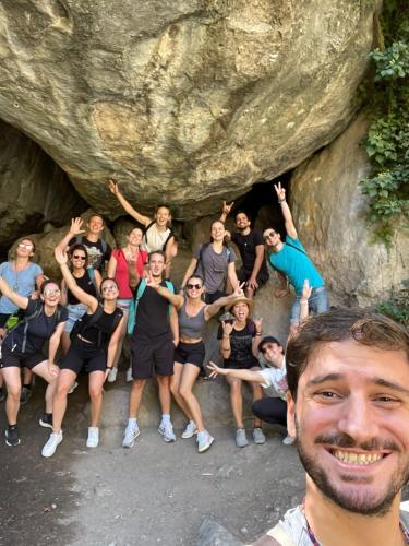 a group of people posing in a cave at ECO Hostel in Granada