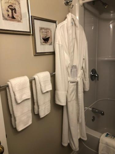 a bathroom with white towels hanging on a wall at Casa Blanca Boutique Bed & Breakfast in Niagara-on-the-Lake