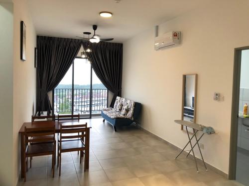 a living room with a table and a chair at Sandakan Homestay Sea-Forest View Apartment 2R2B 海森雙景公寓 in Sandakan