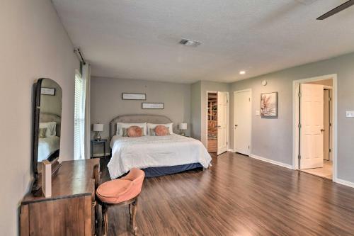 a bedroom with a bed and a wooden floor at Lake Access and Pool Spacious Freeport Home! in Freeport
