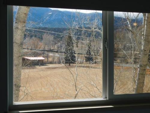 an open window with a view of a field at Silver Ridge Lodge in Salida
