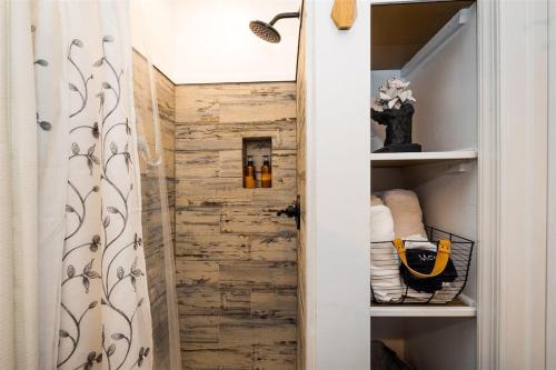 a bathroom with a closet with a wooden wall at Tiny House 3 min from Down Town Cape Charles in Cape Charles