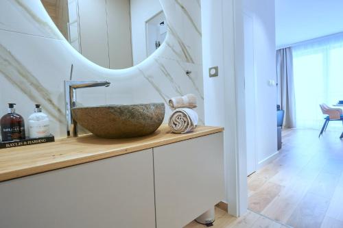 a bathroom with a sink and a mirror at The Gatsby Apartment in Poprad