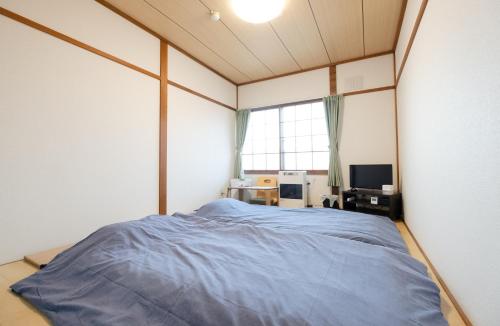Postel nebo postele na pokoji v ubytování Guest House Matsuyoshi