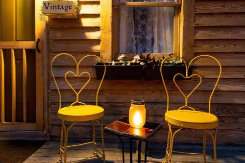 two yellow chairs and a table with a candle at Cape Charles Tiny Livin' in Cape Charles