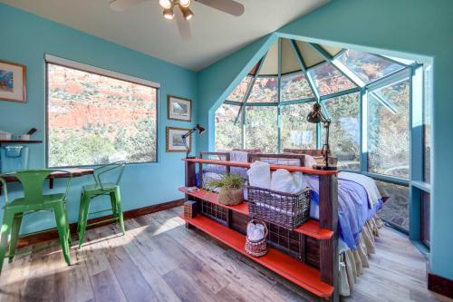 a bedroom with blue walls and a bed and a table at Sedona Studio with Amazing View and On-Site Hiking! in Sedona