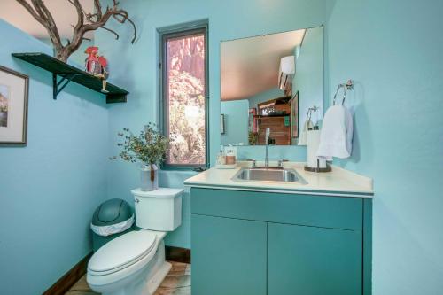 a blue bathroom with a toilet and a sink at Sedona Studio with Amazing View and On-Site Hiking! in Sedona