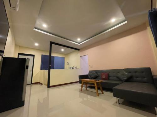 a living room with a couch and a table at BN Resort in Ban Nong Chum Saeng