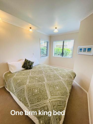 a bedroom with a large bed in a room at Habour View - Tauranga Central in Tauranga