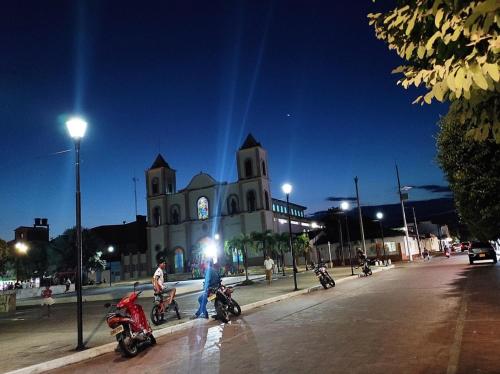 a group of motorcycles parked in front of a church at HOTEL EMPRESARIAL Arcoiris de mi llano in Paz de Ariporo