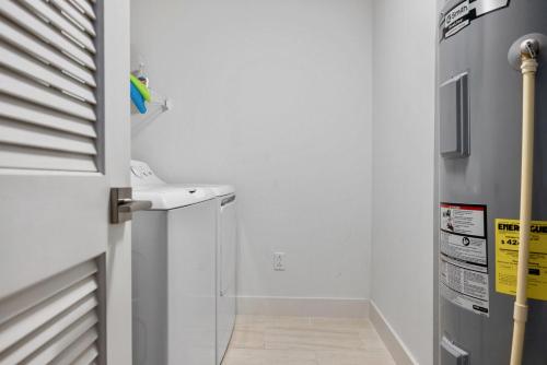 a small kitchen with a sink and a refrigerator at Luxury Calypso Tower 3! Free Beach Chair Service for 4! by Dolce Vita Getaways PCB in Panama City Beach