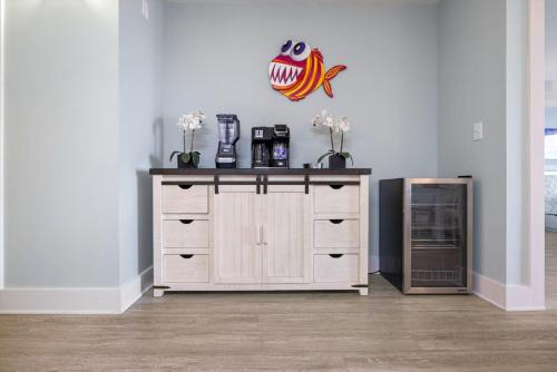 a dresser in a room with a fish on the wall at Luxury Calypso Tower 3! Free Beach Chair Service for 4! by Dolce Vita Getaways PCB in Panama City Beach