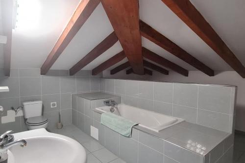 La salle de bains est pourvue de toilettes blanches et d'un lavabo. dans l'établissement Magnifique villa avec piscine en bord de Mer, à Lucciana