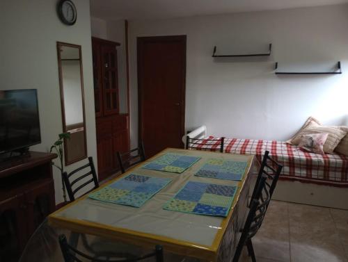 a dining room with a table and a bed at FREEDOM Joa in Río Gallegos