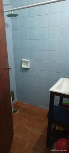 La salle de bains est pourvue de carrelage bleu et blanc. dans l'établissement Apartamento económico, à Villa Gesell