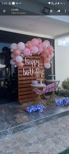 a bunch of pink balloons and a sign that says happy birthday at HOTEL EMPRESARIAL Arcoiris de mi llano in Paz de Ariporo