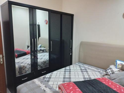 a bedroom with a large mirror and a bed at Second home in Jakarta