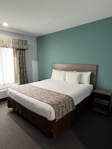 een slaapkamer met een groot bed in een kamer bij Americas Best Value Inn Sulphur in Sulphur