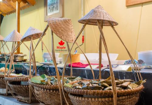 een groep manden gevuld met verschillende soorten voedsel bij Maple Hotel & Apartment in Nha Trang