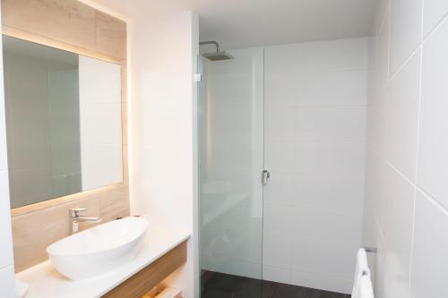 a bathroom with a sink and a mirror at The Esplanade Motel in Batemans Bay