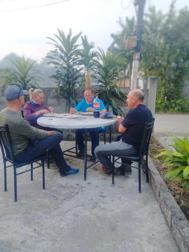 a group of men sitting around a table at Hotel Tiger Tops Sauraha in Sauraha