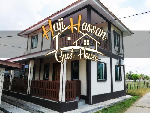 a guest house with a sign that reads joy occasion guest house at Haji Hassan Guesthouse in Pantai Cenang