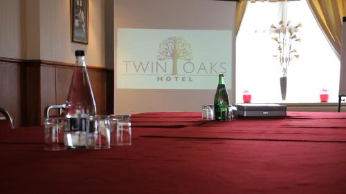 a table with bottles and glasses on a red table cloth at Twin Oaks Hotel in Chesterfield