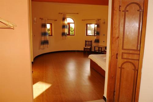 a room with a bed and a wooden floor at Bete Serkie Lalibela in Lalībela