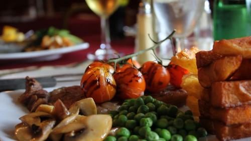 a plate of food with meat and vegetables on a table at Twin Oaks Hotel in Chesterfield