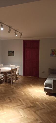 a room with a table and chairs and a red door at Liberty art apartment in Tbilisi City