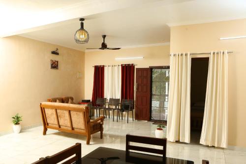 a living room with a table and a dining room at PAUL'S HOME STAY in Cochin