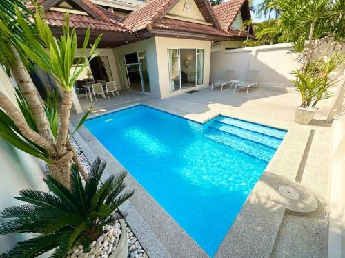 a large blue swimming pool next to a house at View Talay Villas - Luxury, 2 Bedroom - private pool villa, 500m from Jomtien beach - VTV 86 in Jomtien Beach