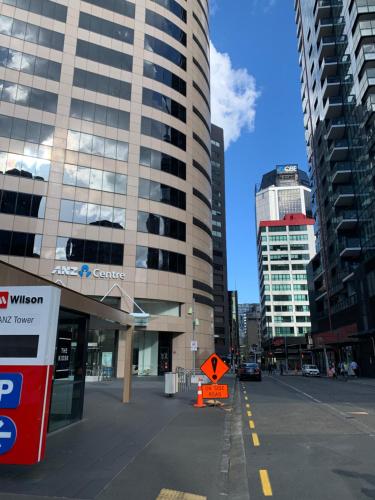 a city street with tall buildings in a city at Garden Hostel in Auckland