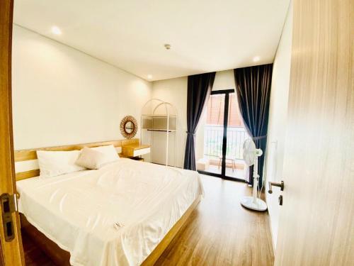a bedroom with a white bed and a large window at 2915 Hạ Long in Ha Long