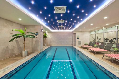 a swimming pool in a hotel with a ceiling with stars at Grand S Hotel in Istanbul