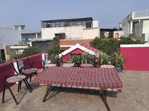 a table and chairs on top of a rooftop at Thomas Home Stay in Agra